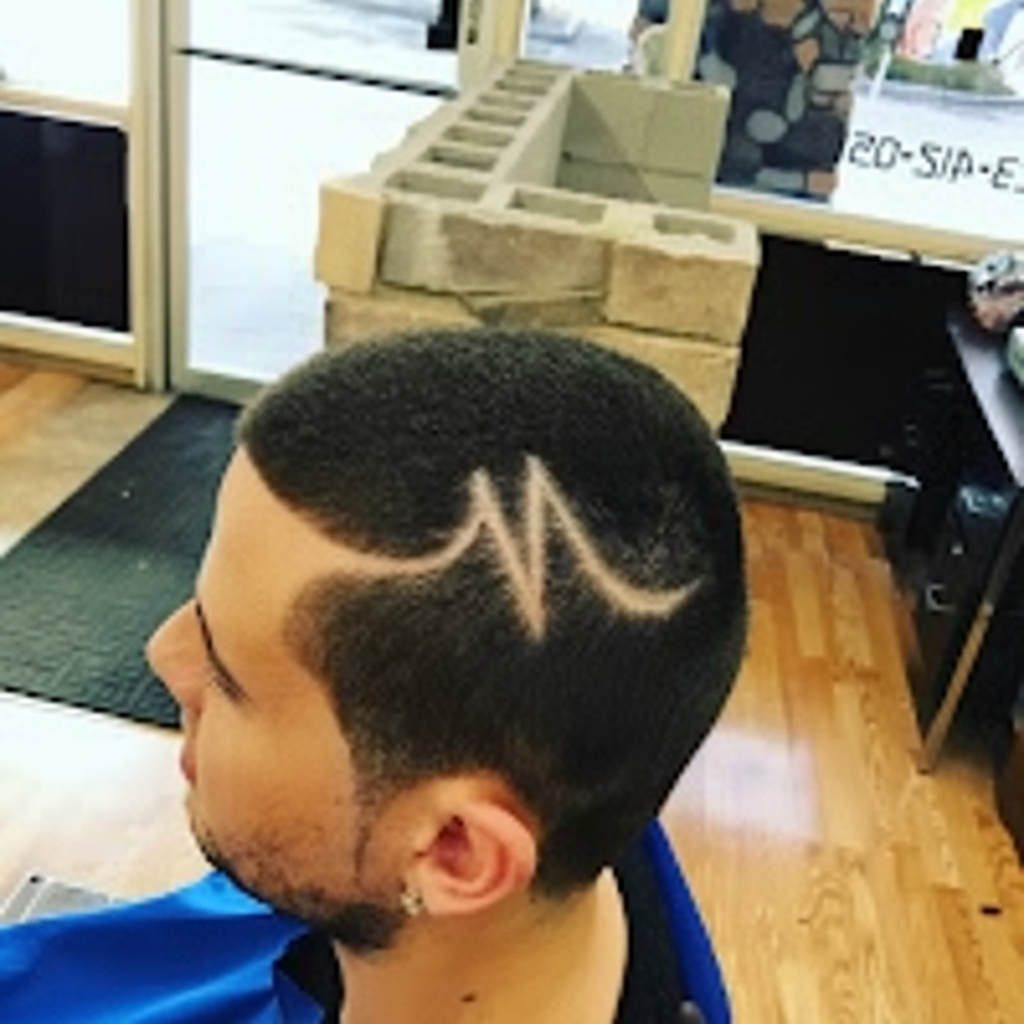 Skin fade with custom 'M' hair design